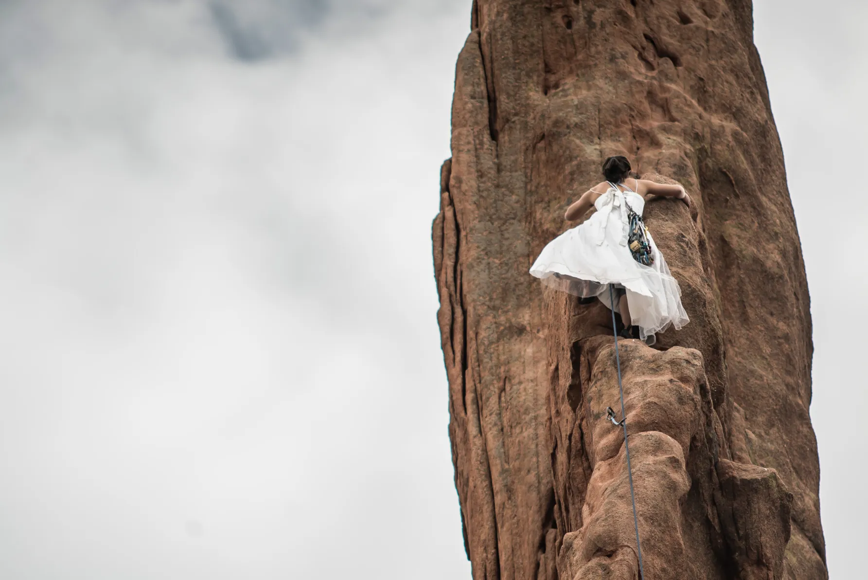 bride climbing to groom at garden of the gods in colorado springs co