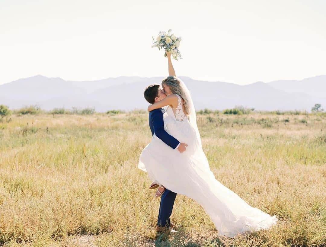 bride and groom celebrating couples portraits with rocky mountains colorado in the background